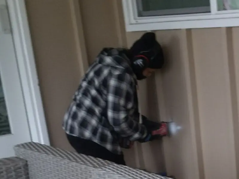 Professional electrician installing an exterior outlet in Poland
