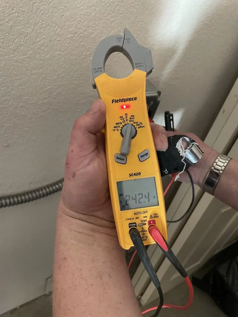 Voltage testing with clamp meter during Ceiling Fan Installation in Poland